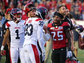 The Calgary Stampeders' Don Jackson talks with the Montreal Alouettes Jarnor Jones as they await a review after Eric Rogers' touchdown pass. The pass was eventually ruled caught out of bounds ending the Stampeders chance in overtime against the Montreal Alouettes during CFL action in Calgary on Saturday August 17, 2019. The Alouettes won 40-34. Gavin Young/Postmedia