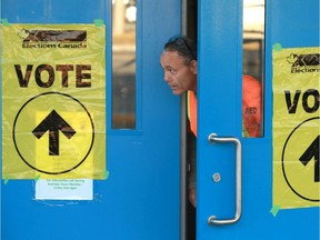 Peter Guterson pokes his head out the door after voting in the 2019 federal election at Cambrian Heights School on Northmount Dr NW in Calgary on Monday, October 21, 2019. Jim Wells/Postmedia