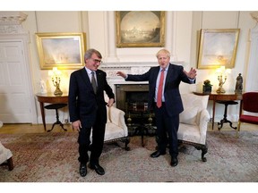 Britain's Prime Minister Boris Johnson (R) interacts with European Parliament president David Sassoli prior to a private meeting at 10 Downing Street for a meeting in London on Oct. 8, 2019.