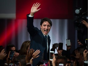 Prime minister Justin Trudeau celebrates his victory with his supporters at the Palais des Congres in Montreal during Team Justin Trudeau 2019 election night event in Montreal, Canada on October 21, 2019. - Prime Minister Justin Trudeau's Liberal Party held onto power in a nail-biter of a Canadian general election on Monday, but as a weakened minority government. Television projections declared the Liberals winners or leading in 157 of the nation's 338 electoral districts, versus 121 for his main rival Andrew Scheer and the Conservatives, after polling stations across six time zones closed. (Photo by Sebastien ST-JEAN / AFP)