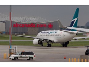A Westjet plane taxis to the runway at Montreal's Pierre Elliot Trudeau airport in Montreal Wednesday June 29, 2011.