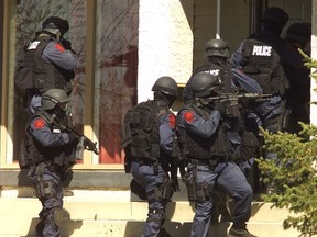 Calgary Police Service's tactical members enter a home in an undated file photo.