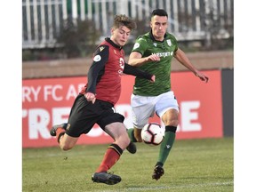 Canadian Premier League - Cavalry FC v Valour FC - Calgary, Alberta, Canada  Oct. 2, 2019  Tyler Attardo of Valour FC kicks the ball away from Dominik Zator of Cavalry FC Mike Sturk/CPL