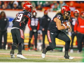 Calgary Stampeders quarterback Bo Levi Mitchell hands off to running back Ante Milanovic-Litre during CFL football against the Saskatchewan Roughriders in Calgary on Friday, October 11, 2019. Al Charest/Postmedia