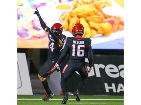 The Calgary Stampeders' Jamari Gilbert celebrates his touchdown after returning an onside kick against the Saskatchewan Roughriders during CFL football in Calgary on Friday. Photo by Al Charest/Postmedia.