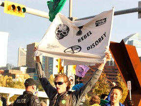 Marshall Meinema joins climate activists blocking traffic along Memorial Drive in Kensington as they join other Canadians in a global climate strike led by "Extinction Rebellion." Many motorists trying to leave the downtown core during rush hour were heard honking horns in disapproval.  Monday, October 7, 2019. Brendan Miller/Postmedia