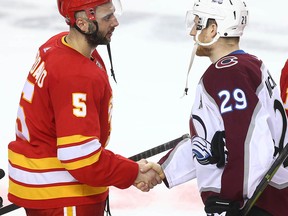 Flames Mark Giordano (L) shakes hands with Avalanche Nathan MacKinnon following game five between the Colorado Avalanche and Calgary Flames in Calgary on Friday, April 19, 2019. Flames lost 5-1.