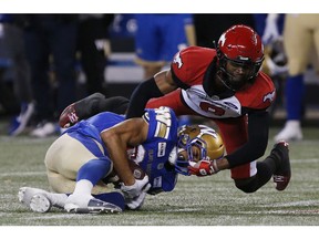 CP-Web.  Winnipeg Blue Bombers' Kenny Lawler (89) makes the catch as Calgary Stampeders' DaShaun Amos (8) defends during the second half of CFL action in Winnipeg Friday, October 25, 2019.