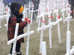 Jaydyn Shea,8, was among hundreds of volunteers who installed over 3400 crosses at the Field of Crosses for their 11th year on Memorial Drive in Calgary on Saturday, October 26, 2019. Darren Makowichuk/Postmedia