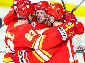 Calgary Flames Elias Lindholm celebrates with teammates after his goal against Jimmy Howard of the Detroit Red Wings on Thursday, Oct. 17, 2019.