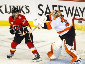 Calgary Flames Matthew Tkachuk battles Philadelphia Flyers Brian Elliott in second period action at the Scotiabank Saddledome in Calgary on Tuesday, Oct. 15, 2019.