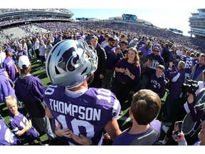 Oct 26, 2019; Manhattan, KS, USA; Kansas State Wildcats quarterback Skylar Thompson (10) poses for photos with fans on the field following a win against the Oklahoma Sooners at Bill Snyder Family Stadium. Mandatory Credit: Scott Sewell-USA TODAY Sports ORG XMIT: USATSI-404299