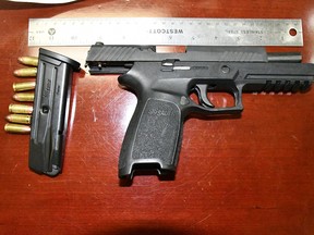 A gun and ammunition seized by RCMP in Drumheller over the weekend. Two people from Alberta are facing multiple charges.