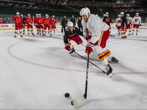 Calgary Flames' Milan Lucic (17), right, and Noah Hanifin (55) take part in a drill during practice for the NHL Heritage Classic outdoor hockey game in Regina on Friday,October 25, 2019. THE CANADIAN PRESS/Liam Richards