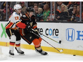 October 20, 2019; Anaheim, CA, USA; Anaheim Ducks defenseman Hampus Lindholm (47) plays for the puck against Calgary Flames left wing Johnny Gaudreau (13) during the first period at Honda Center. Mandatory Credit: Gary A. Vasquez-USA TODAY Sports ORG XMIT: USATSI-405121