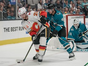 Calgary Flames center Elias Lindholm (28) and San Jose Sharks defenseman Marc-Edouard Vlasic (44) battle for the puck during the first period at SAP Center at San Jose. Mandatory Credit: Stan Szeto-USA TODAY Sports ORG XMIT: USATSI-405070