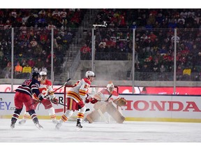 Oct 26, 2019; Regina, Saskatchewan, CAN; Calgary Flames goaltender David Rittich (33) watches play against the Winnipeg Jets during the first period of the 2019 Heritage Classic outdoor hockey game at Mosaic Stadium. Mandatory Credit: Anne-Marie Sorvin-USA TODAY Sports ORG XMIT: USATSI-405162