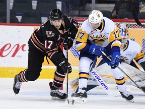 The Calgary Hitmen and Saskatoon Blades battle at the Saddledome on Sunday, October 14, 2019.