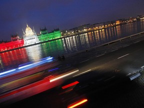 The building of the Hungarian Parliament is lighted by national tricolor lights to commemorate the 1956 uprising against Soviet occupation during the national day on the bank of the river Danube in downtown Budapest, on October 23, 2009. Hungary's uprising which erupted on October 23, 1956 and was crushed by Soviet tanks on November 4, sealing the country's fate as a satellite state of Moscow until the fall of the Iron Curtain in 1989. AFP PHOTO / FERENC ISZA (Photo credit should read FERENC ISZA/AFP/Getty Images)