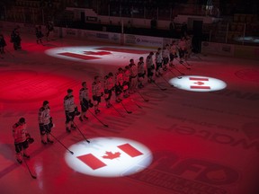 The AJHL Calgary Mustangs line up for the national anthem before facing the Fort McMurray Oil Barons on Jan. 13, 2017.