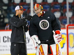 Calgary Flames goaltender David Rittich and goalie coach Jordan Sigalet prepare for Thursday's season opener against the Colorado Avalanche.