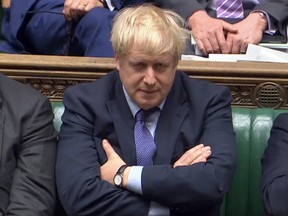 A video grab from footage broadcast by the UK Parliament's Parliamentary Recording Unit shows Prime Minister Boris Johnson reacting during the debate on the Brexit withdrawal agreement bill in the House of Commons in London on October 22, 2019. (HO / PRU / AFP)