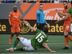 Oct 26, 2019; Hamilton, Ontario, CAN;  Referee Pierre-Luc Lauziere indicates a penalty after a fould by Cavalry FC defender Joel Waterman (15) against Forge FC in the first half of a Canadian Premier League soccer final match at Tim Hortons Field. Mandatory Credit: Dan Hamilton-USA TODAY Sports for CPL ORG XMIT: USATSI-415705