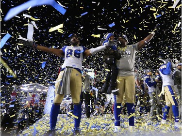 The Winnipeg Blue Bombers' Rasheed Bailey raises his arms with teammates as they celebrate in the confetti after the Bombers defeated the Hamilton Tiger-Cats 33-12 to win the 107th Grey Cup in Calgary Sunday, November 24, 2019. Gavin Young/Postmedia