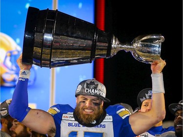 Winnipeg Blue Bombers Chris Streveler celebrates with the Grey Cup after defeating the Hamilton Tiger-Cats in the 107th Grey Cup in Calgary on Sunday, November 24, 2019 i. Al Charest/Postmedia