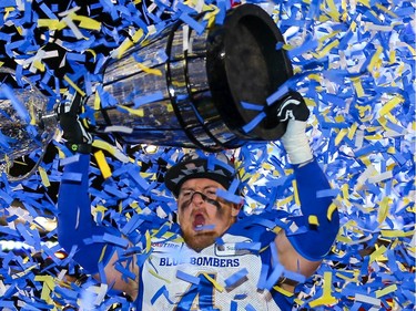 Winnipeg Blue Bombers Adam Bighill celebrates with the Grey Cup after defeating the Hamilton Tiger-Cats in the 107th Grey Cup in Calgary on Sunday, November 24, 2019 i. Al Charest/Postmedia