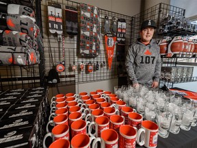 Riley Anderson, retail operation manager at Grey Cup store, poses for a photo with some of the merchandise at the store on Wednesday, November 20, 2019. Azin Ghaffari/Postmedia Calgary