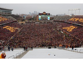 MINNEAPOLIS, MN - NOVEMBER 09: Minnesota Golden Gophers and fans storm the field while hoisting the Governor's Victory Bell after defeating the Penn State Nittany Lions 31-26 to remain undefeated at TCFBank Stadium on November 9, 2019 in Minneapolis, Minnesota.