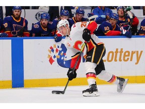 ST LOUIS, MO - NOVEMBER 21: Michael Stone #26 of the Calgary Flames shoots the puck against the St. Louis Blues at Enterprise Center on November 21, 2019 in St Louis, Missouri.