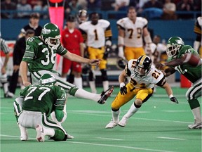 Dave Ridgway, 38, kicks the winning field goal with Glen Suitor, 27, holding the ball to clinch the 1989 Grey Cup against the Hamilton Tiger Cats in Toronto. Mike Cassese/Toronto Sun/QMI Agency