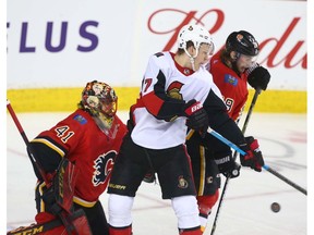 Senators Brady Tkachuk and Flames Elias Lindstrom battle in front of Flames netminder Mike Smith during NHL action between the Ottawa Senators and the Calgary Flames in Calgary on Thursday, March 21, 2019. Jim Wells/Postmedia