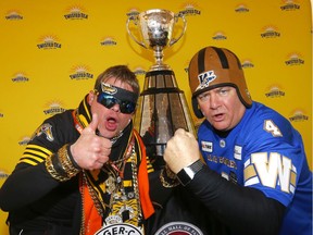 CFL fans Dave Armstrong, left, and Peter Kravetz ham it up during the Grey Cup Festival at Stampede Park in preparation for the 107th Grey Cup in Calgary.