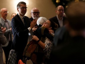 Chantel Sparklingeyes (centre right) hugs Alberta Council of Women's Shelters executive director Jan Reimer during ACWS' annual Breakfast with the Guys event to help members of the construction industry recognize the signs of and interrupt domestic violence impacting their workplaces in Edmonton, on Thursday, Nov. 28, 2019.