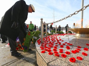 Calgarians place their poppies near the eternal flame at the Military Museums following the Remembrance Day service on Monday November 11, 2019.  Gavin Young/Postmedia