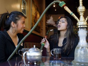 Two women enjoy shisha at Cafe Mediterranean, a hookah lounge in downtown Calgary.