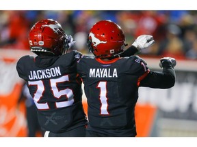 Calgary Stampeders Hergy Mayala celebrates with teammate Don Jackson after his touchdown against the Saskatchewan Roughriders during CFL football in Calgary on Friday, October 11, 2019. Al Charest/Postmedia