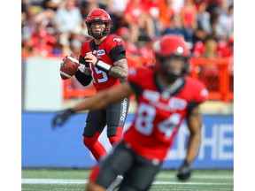 Calgary Stampeders quarterback Bo Levi Mitchell throws a pass to Reggie Begelton against the Hamilton Tiger-Cats during CFL football in Calgary earlier this season. File photo by Al Charest/Postmedia.