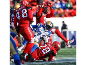 Winnipeg Blue Bombers Andrew Harris is tackled by Brandon Smith of the Calgary Stampeders during the CFL West Division semifinal in Calgary on Sunday, November 10, 2019. Al Charest/Postmedia