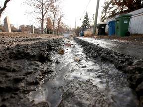 A rutted alley is shown in the northwest community of Banff Trail in Calgary on Saturday, November 16, 2019. The city reduced its laneway repairs budget by 10 per cent this year as part of budget cuts. Jim Wells/Postmedia