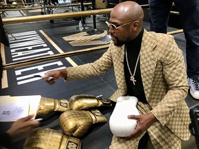 Floyd Mayweather signs gloves at the opening of the Mayweather Boxing + Fitness gym in Torrance, California, November 16, 2019. (REUTERS/Rory Carroll)