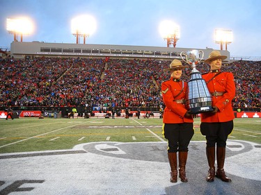RCMP officers escort the Grey Cup championship trophy onto the field during the 107th Grey Cup CFL championship football game in Calgary on Sunday, November 24, 2019. Al Charest/Postmedia