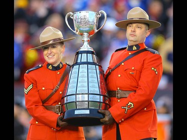 RCMP officers escort the Grey Cup championship trophy onto the field during the 107th Grey Cup CFL championship football game in Calgary on Sunday, November 24, 2019. Al Charest/Postmedia