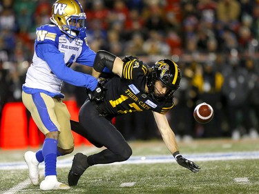 Winnipeg Blue Bombers, Marcus Sayles knocks the pass away from Hamilton Tiger-Cats, Luke Tasker in first half action at McMahon stadium during the 107th Grey Cup in Calgary on Sunday, November 24, 2019. Darren Makowichuk/Postmedia