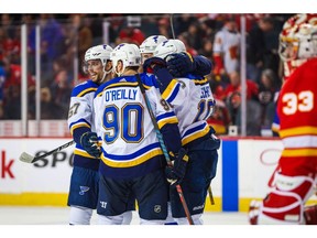 Nov 9, 2019; Calgary, Alberta, CAN; St. Louis Blues left wing David Perron (57) celebrates his goal with teammates against the Calgary Flames during the overtime period at Scotiabank Saddledome. Mandatory Credit: Sergei Belski-USA TODAY Sports ORG XMIT: USATSI-405254