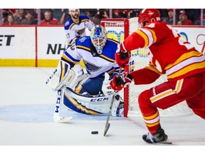 Nov 9, 2019; Calgary, Alberta, CAN; St. Louis Blues goaltender Jordan Binnington (50) guards his net as Calgary Flames defenseman Travis Hamonic (24) tries to score during the third period at Scotiabank Saddledome. Mandatory Credit: Sergei Belski-USA TODAY Sports ORG XMIT: USATSI-405254