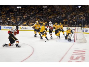 Calgary Flames winger Matthew Tkachuk (19) scores goal on Nashville Predators goaltender Pekka Rinne (35) during the third period at Bridgestone Arena. Photo by Steve Roberts/USA TODAY Sports.